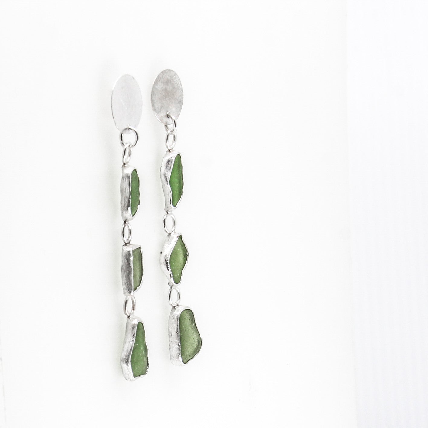 long green dangling sea glass earrings with textured 925 sterling silver disc