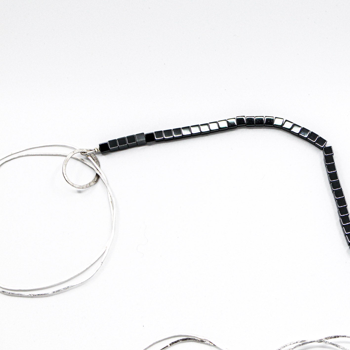 extra long minimalist statement necklace with hematite cubes and sterling silver rings